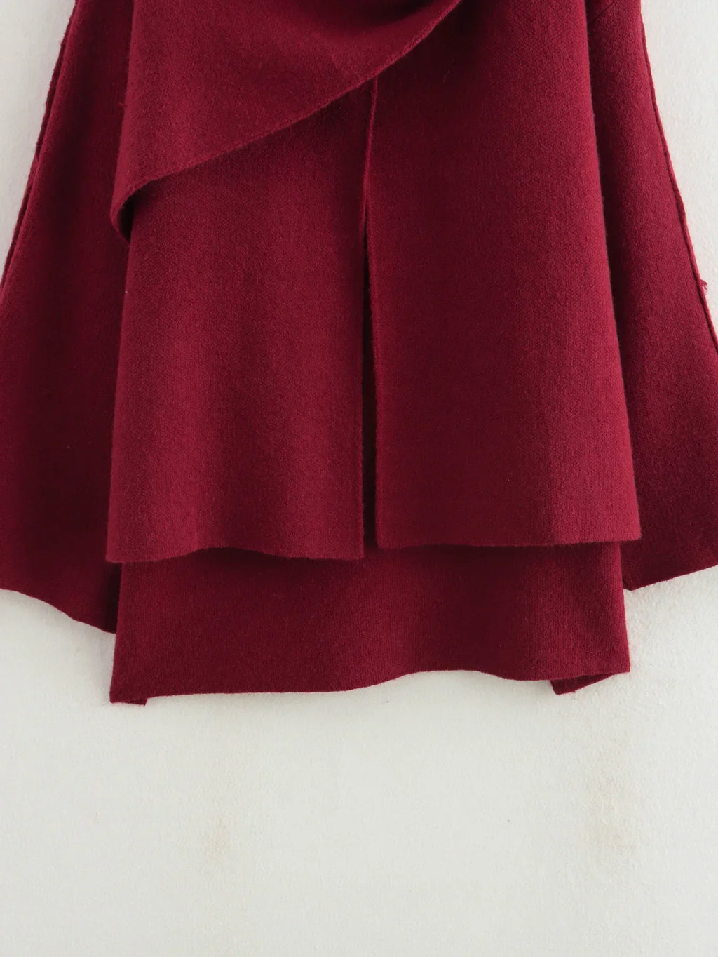Luxurious knitted coat with asymmetric design — elegance and cozy warmth in one.