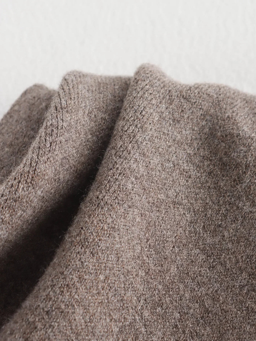 Luxurious knitted coat with asymmetric design — elegance and cozy warmth in one.
