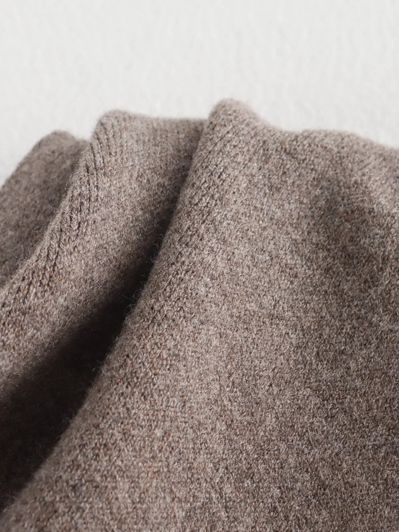 Luxurious knitted coat with asymmetric design — elegance and cozy warmth in one.